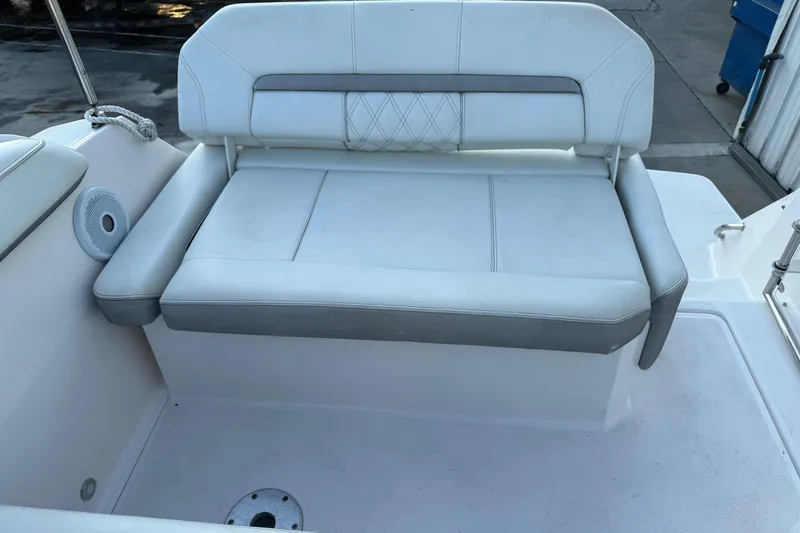Slide: The Image of 2020 Regal 26 XO boat seating area with white and gray upholstery. - 14