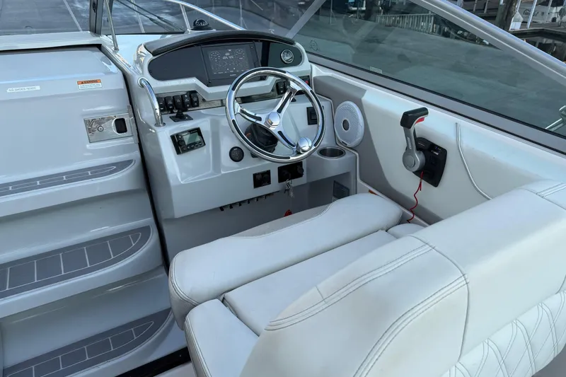 Slide: The Image of 2020 Regal 26 XO boat cockpit with steering wheel and control panel. - 15