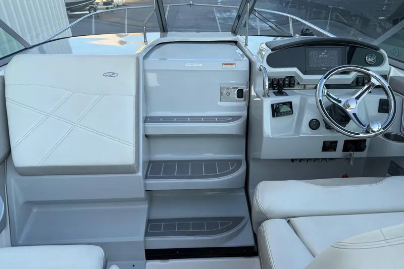 Slide: The Image of 2020 Regal 26 XO boat cockpit with steering wheel and control panel. - 17