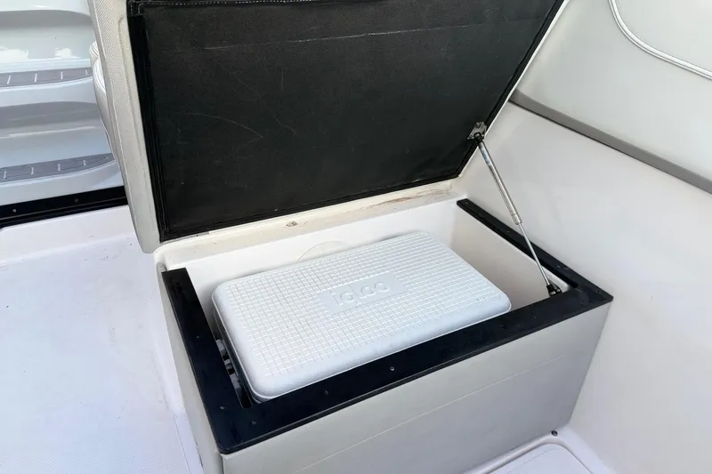 Slide: The Image of Storage compartment with Igloo cooler on 2020 Regal 26 XO boat. - 27