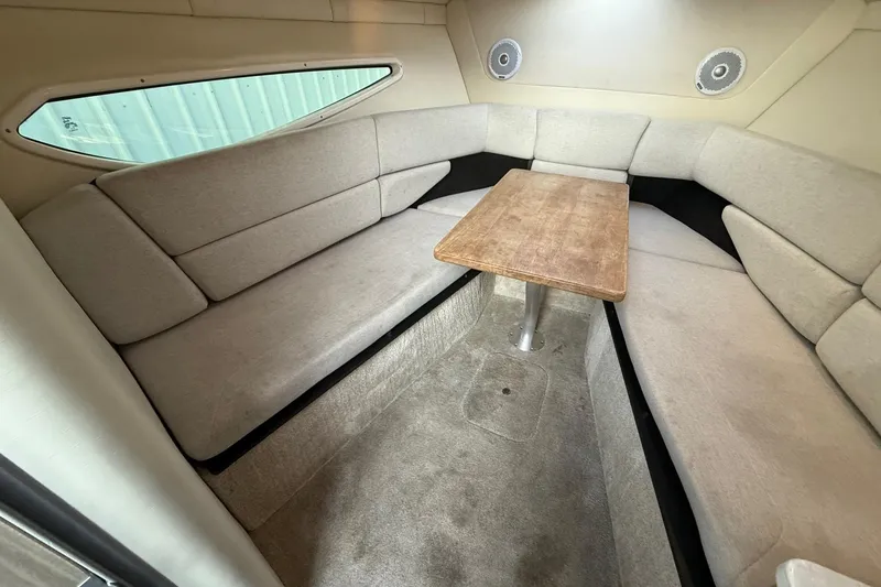 Slide: The Image of 2020 Regal 26 XO boat interior with beige seating and wooden table. - 29
