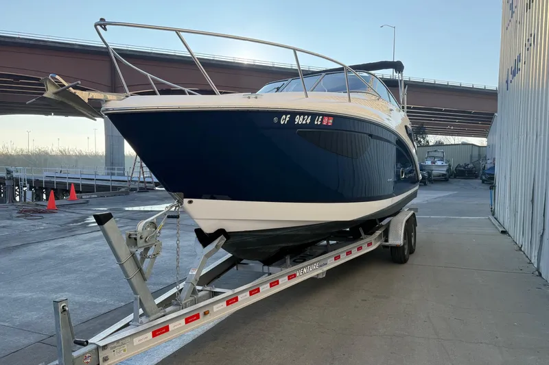 Slide: The Image of 2020 Regal 26 XO boat on trailer near dock and bridge. - 4