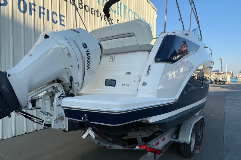 Slide: The Image of 2020 Regal 26 XO boat with Yamaha engine on trailer, dockside view. - 6
