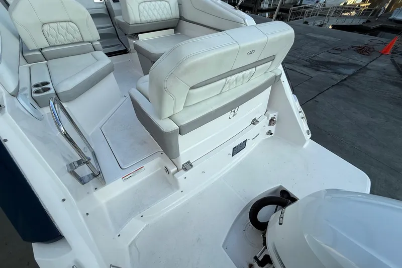 Slide: The Image of 2020 Regal 26 XO boat interior with white seating and engine view. - 9