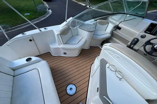 Slide: The Image of 2008 Sea Ray 240 Sundancer boat interior with seating and steering wheel. - 10