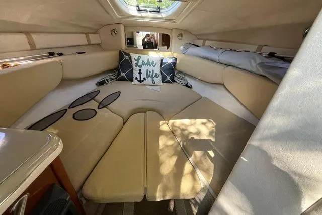 Slide: The Image of Interior of 2008 Sea Ray 240 Sundancer with beige seating and decorative pillows. - 19