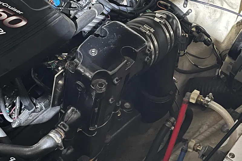 Slide: The Image of Engine compartment of a 2008 Sea Ray 240 Sundancer boat, showcasing mechanical components. - 27