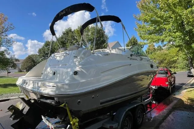 Slide: The Image of 2008 Sea Ray 240 Sundancer boat on trailer, parked on a sunny street. - 5