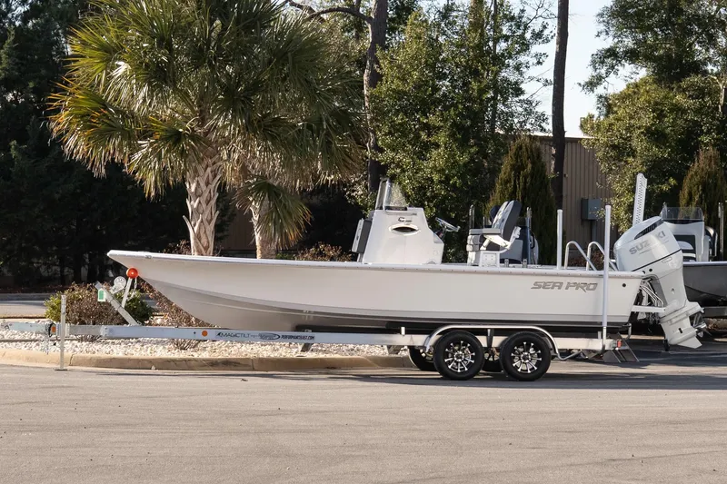 The Image of 2026 Sea Pro 230 Bay boat on trailer, parked near palm trees. - 1