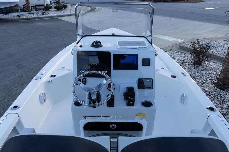 Slide: The Image of 2026 Sea Pro 230 Bay boat dashboard with steering wheel and navigation controls. - 10