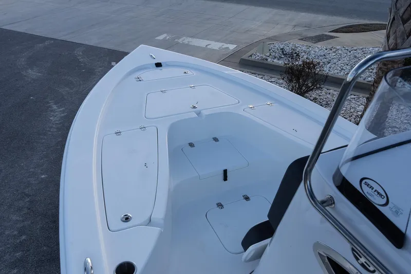 Slide: The Image of 2026 Sea Pro 230 Bay boat deck with storage compartments and console. - 12