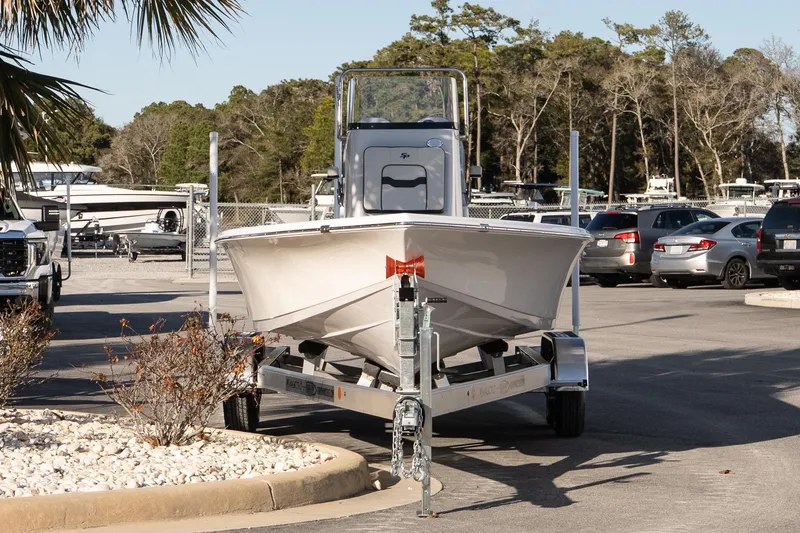 Slide: The Image of 2026 Sea Pro 230 Bay boat on trailer in parking lot, surrounded by cars and trees. - 3
