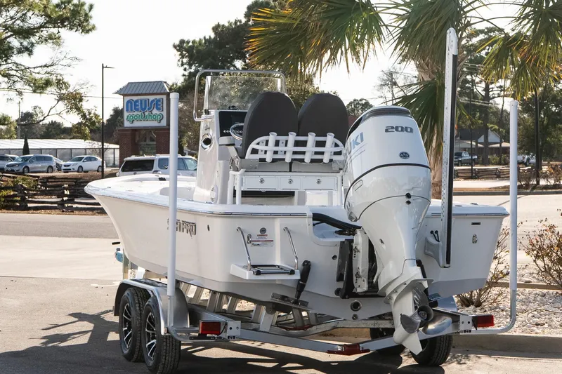 Slide: The Image of 2026 Sea Pro 230 Bay boat on trailer, parked near Neuse Sport Shop. - 4