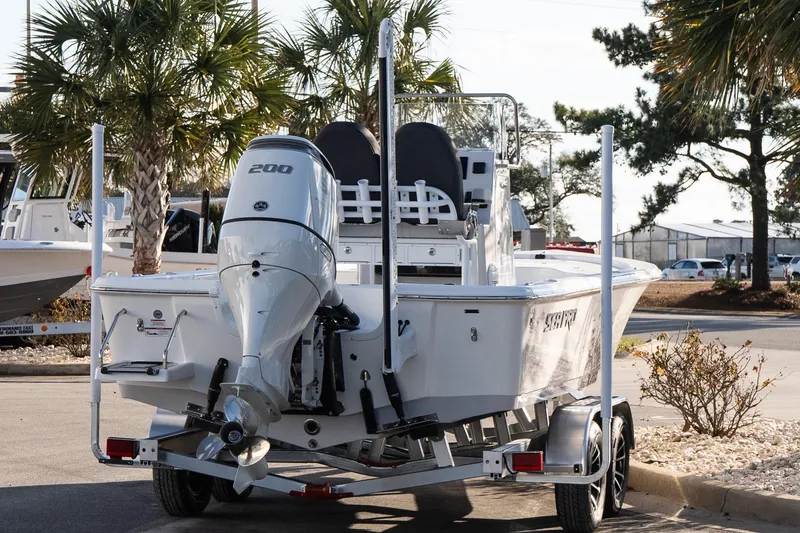 Slide: The Image of 2026 Sea Pro 230 Bay boat on trailer, parked near palm trees. - 6