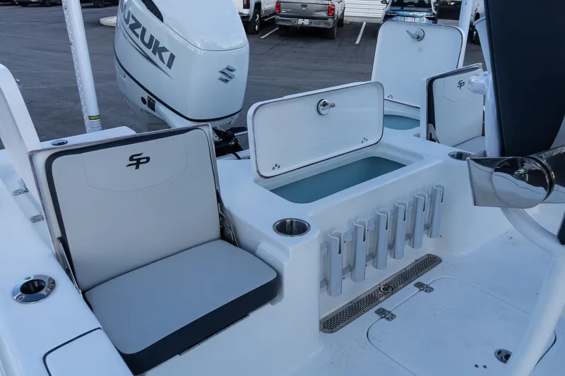Slide: The Image of 2026 Sea Pro 230 Bay boat interior with Suzuki engine, featuring seating and storage compartments. - 9