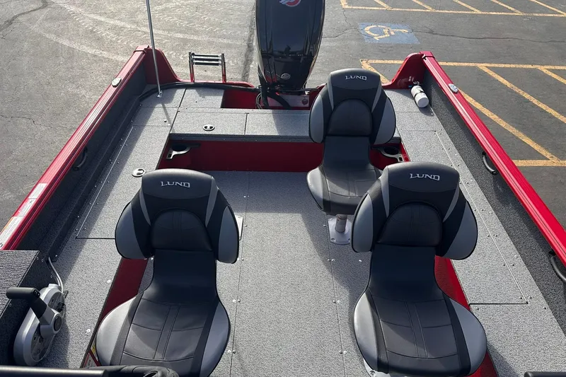 Slide: The Image of 2026 Lund 1800 Explorer Sport boat interior with three seats and motor. - 10