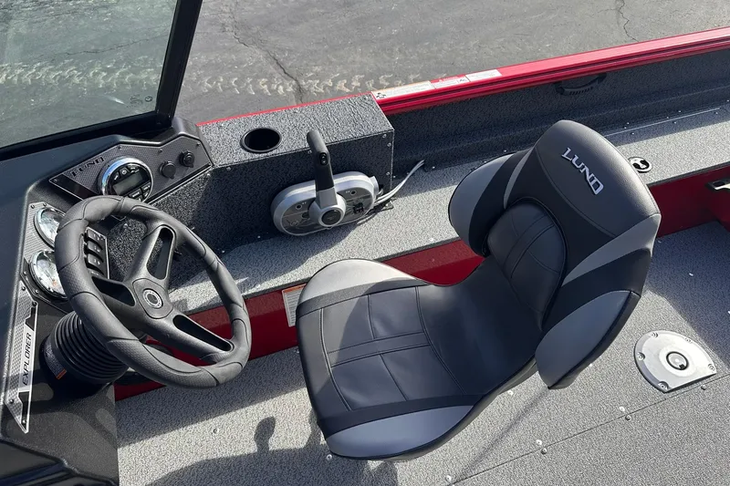 Slide: The Image of 2026 Lund 1800 Explorer Sport boat interior with steering wheel and seat. - 11
