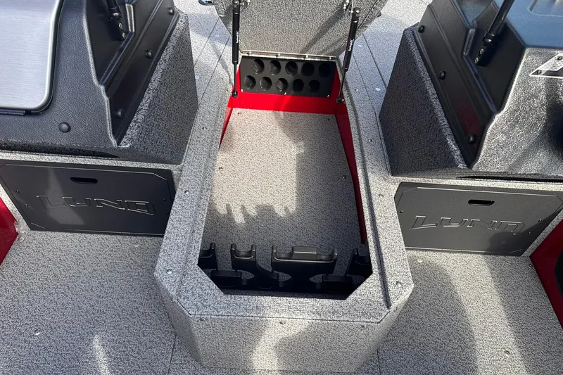 Slide: The Image of 2026 Lund 1800 Explorer Sport boat interior with storage compartments and rod holders. - 14