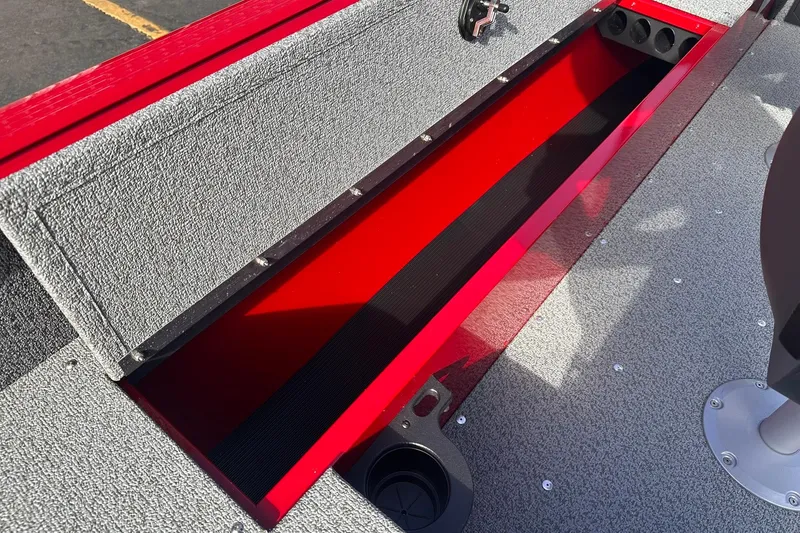 Slide: The Image of 2026 Lund 1800 Explorer Sport boat interior storage compartment, red and gray design. - 17