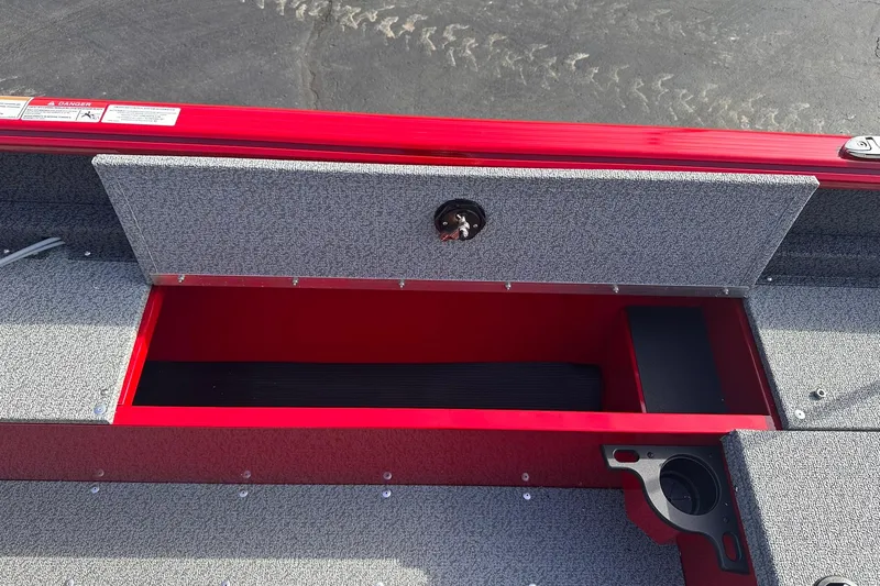 Slide: The Image of 2026 Lund 1800 Explorer Sport boat storage compartment with open lid, showcasing interior space. - 19