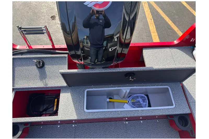 Slide: The Image of 2026 Lund 1800 Explorer Sport boat interior with storage compartments and motor. - 20