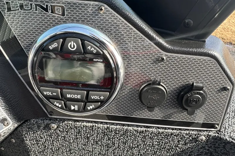Slide: The Image of Control panel of 2026 Lund 1800 Explorer Sport boat with audio and power inputs. - 22