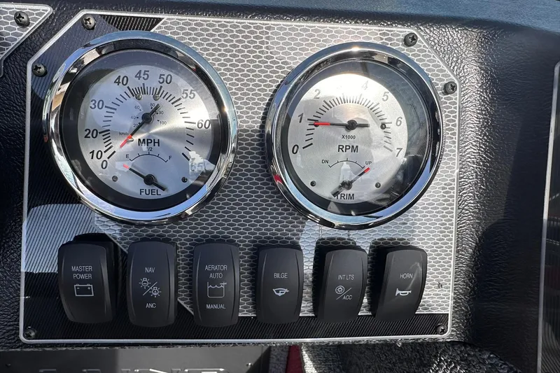 Slide: The Image of Dashboard of 2026 Lund 1800 Explorer Sport with gauges and control switches. - 23
