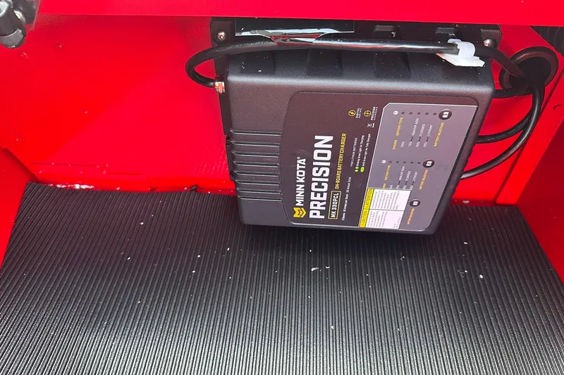 Slide: The Image of Minn Kota Precision charger in 2026 Lund 1800 Explorer Sport boat, red interior. - 24