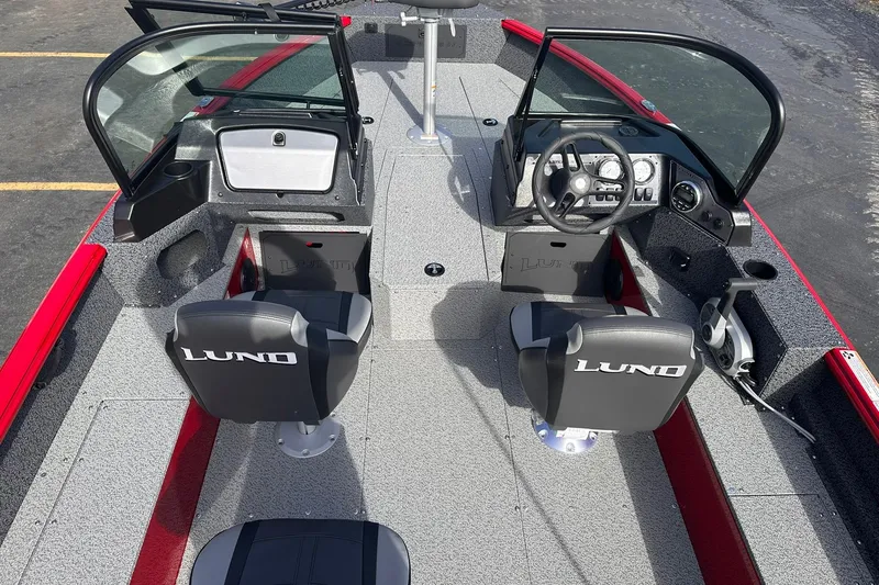 Slide: The Image of 2026 Lund 1800 Explorer Sport boat interior with dual seats and steering console. - 6