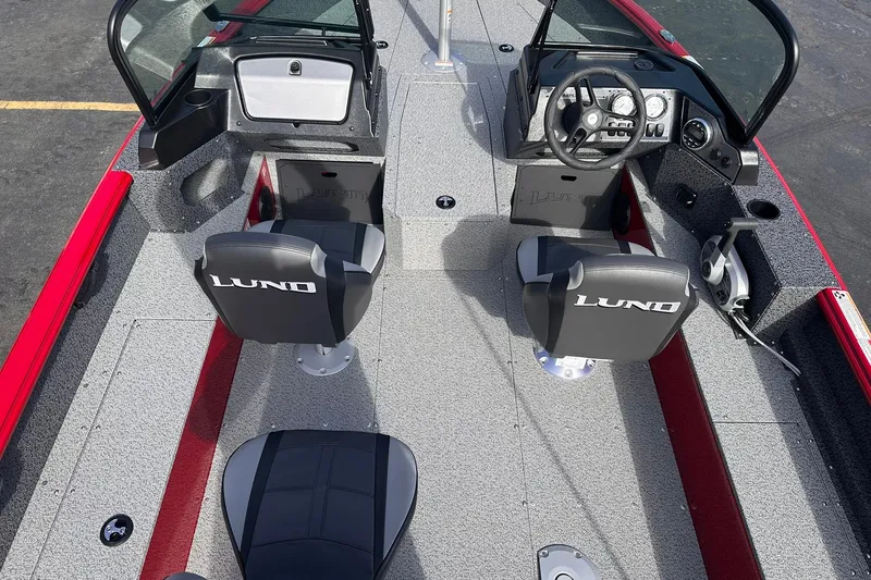Slide: The Image of 2026 Lund 1800 Explorer Sport boat interior with dual seats and steering console. - 7
