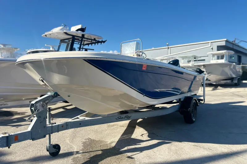 Slide: The Image of 2013 Carolina Skiff 19 Ultra Elite boat on trailer, parked outdoors. - 1