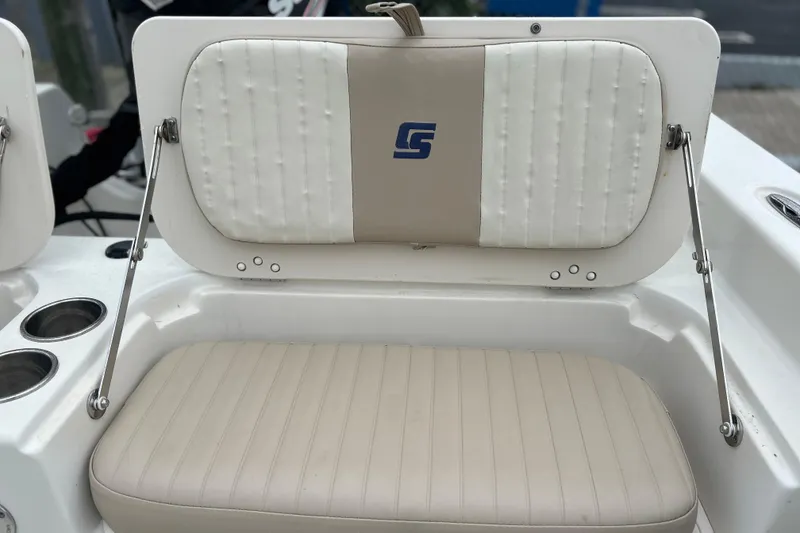 Slide: The Image of 2013 Carolina Skiff 19 Ultra Elite boat seat with cup holders and logo. - 13