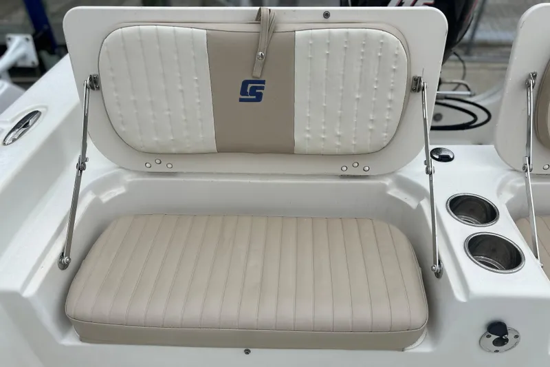 Slide: The Image of 2013 Carolina Skiff 19 Ultra Elite boat seat with cup holders and logo. - 14