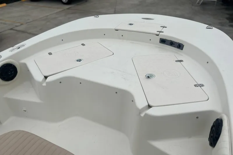 Slide: The Image of 2013 Carolina Skiff 19 Ultra Elite boat deck with storage compartments. - 20