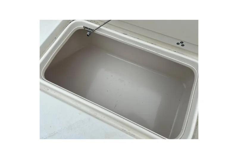 Slide: The Image of 2013 Carolina Skiff 19 Ultra Elite storage compartment, open and empty. - 22