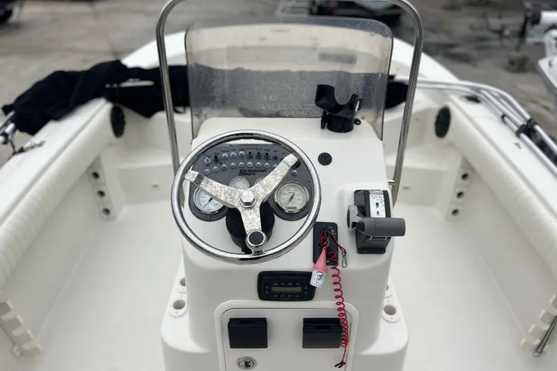 Slide: The Image of 2013 Carolina Skiff 19 Ultra Elite boat console with steering wheel and controls. - 6
