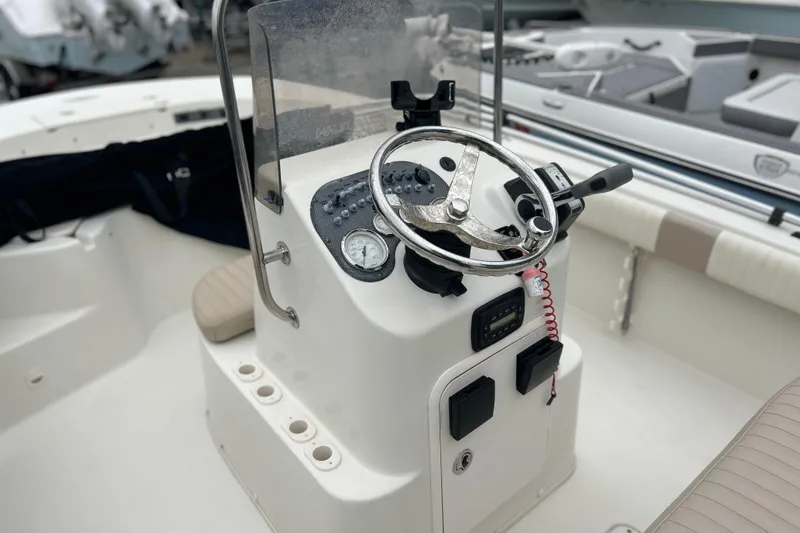 Slide: The Image of 2013 Carolina Skiff 19 Ultra Elite boat console with steering wheel and controls. - 7