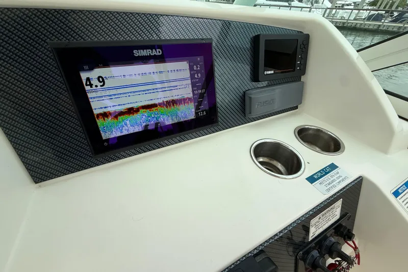 Slide: The Image of Dashboard of 2017 World Cat 230 SD with Simrad display and cup holders. - 18