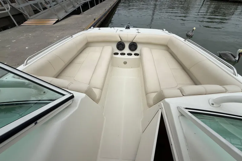 Slide: The Image of 2017 World Cat 230 SD boat interior with beige seating and cup holders at dock. - 20