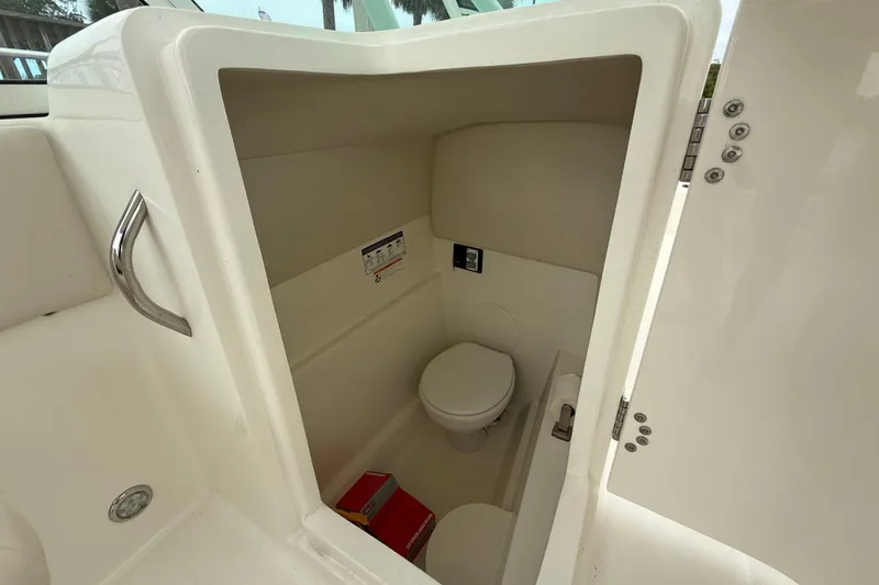 Slide: The Image of 2017 World Cat 230 SD boat interior with compact marine toilet. - 21