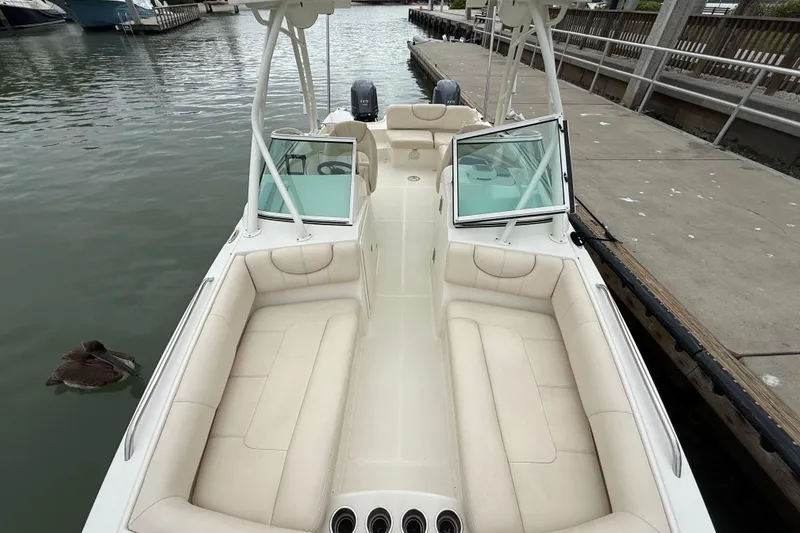 Slide: The Image of 2017 World Cat 230 SD boat with spacious seating, docked by the water. - 22