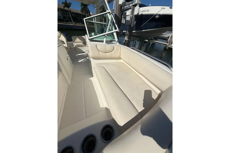 Slide: The Image of 2017 World Cat 230 SD boat interior with beige seating and cup holders. - 7