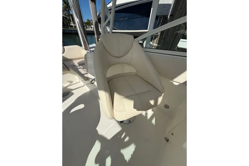 Slide: The Image of 2017 World Cat 230 SD boat interior with beige captain's chair and sleek design. - 8