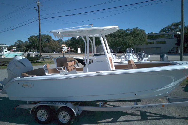 The Image of 2026 Sea Hunt Ultra 219 boat on trailer, parked outdoors, side view. - 0