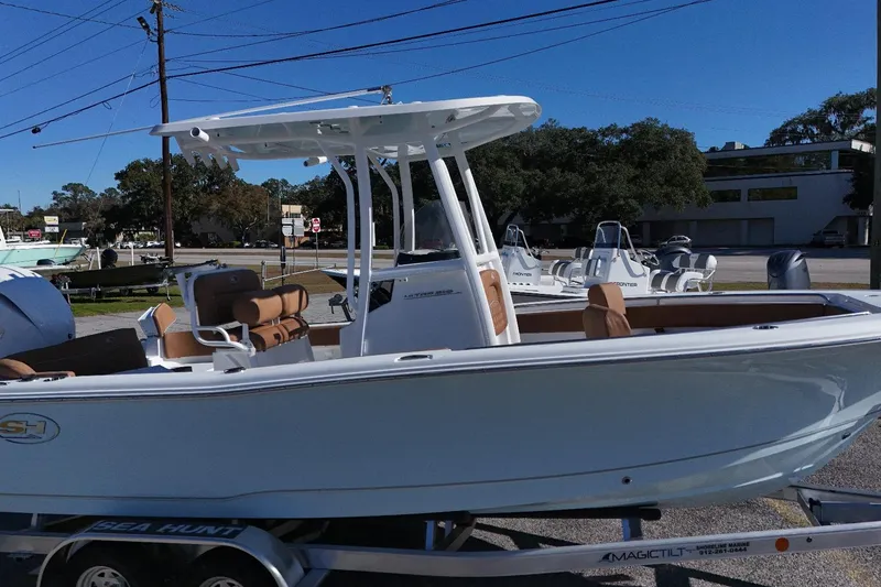 Slide: The Image of 2026 Sea Hunt Ultra 219 boat on trailer, featuring sleek design and modern amenities. - 11