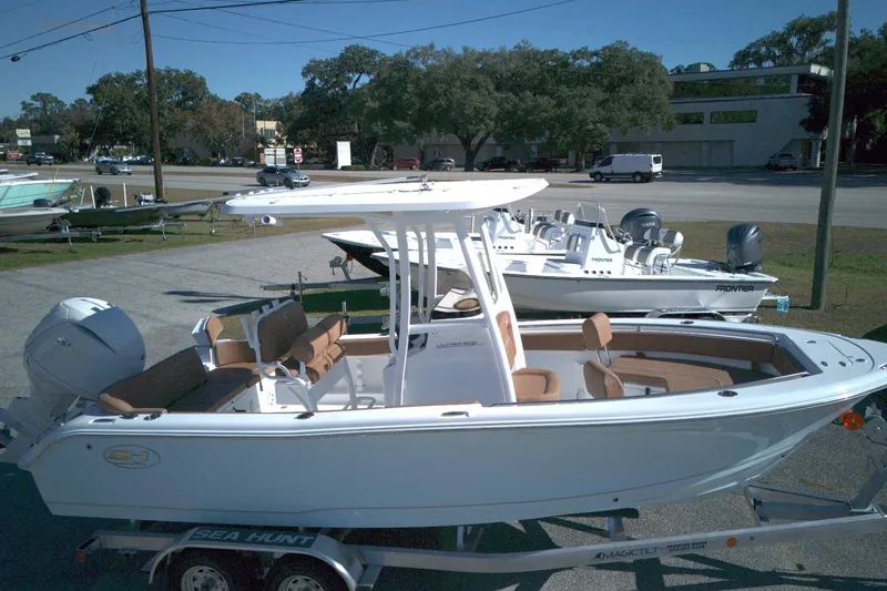 Slide: The Image of 2026 Sea Hunt Ultra 219 boat on trailer, featuring sleek design and spacious seating. - 6