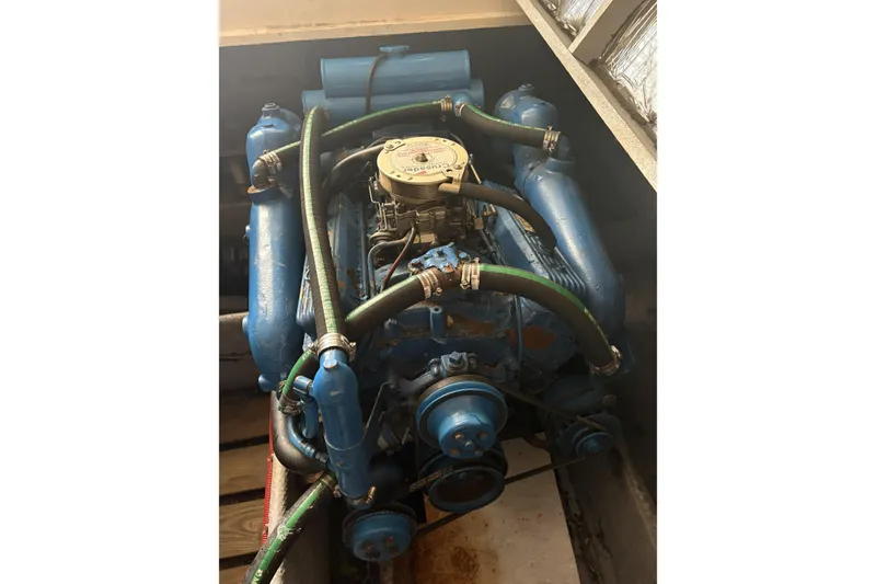 Slide: The Image of Engine of 1988 Silverton 34 Convertible boat, featuring blue components and hoses. - 11