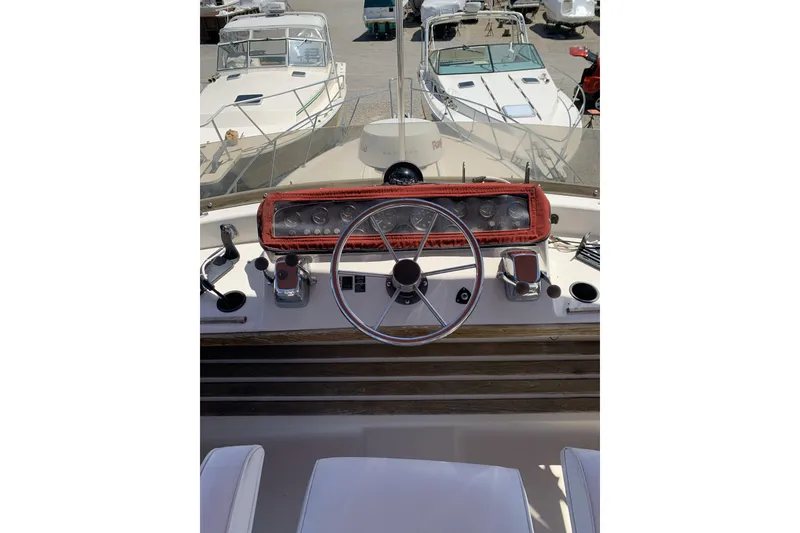 Slide: The Image of 1988 Silverton 34 Convertible boat helm with steering wheel and control panel. - 3