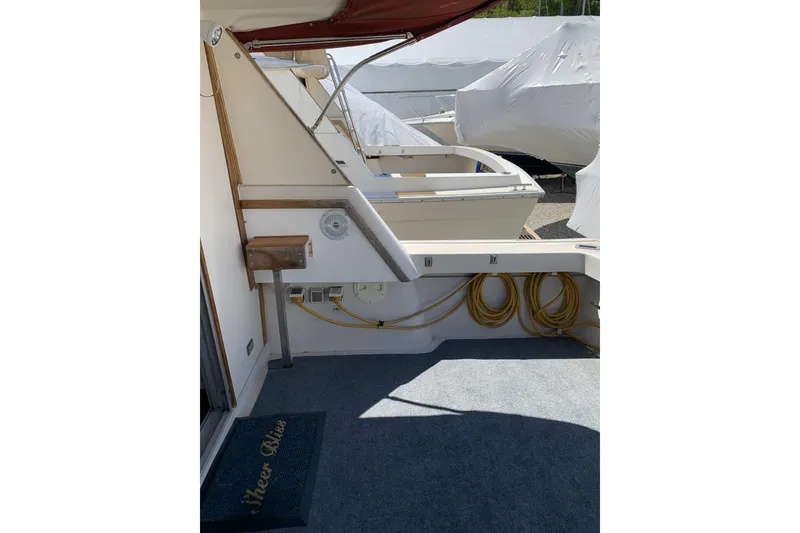 Slide: The Image of 1988 Silverton 34 Convertible boat deck with seating and storage area. - 4