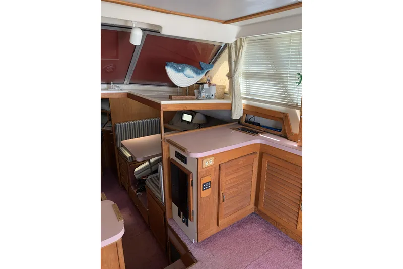 Slide: The Image of Interior of 1988 Silverton 34 Convertible yacht with wood cabinetry and striped seating. - 5